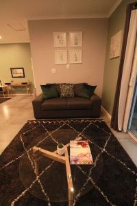 a living room with a couch and a table at Clifton Home in Richards Bay