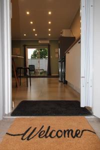a hallway with a welcome mat in a house at Clifton Home in Richards Bay