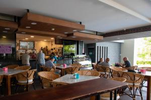 a group of people sitting at tables in a restaurant at Escape II CondominiumE225 in Mae Pim