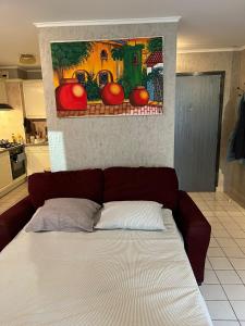 a bed in a kitchen with a painting on the wall at Le Clos du Chateau Rouge 3* avec Parking securisé in Annemasse