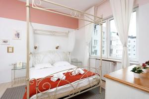 a bedroom with a metal bed with a red blanket at University Apartment in Bucharest