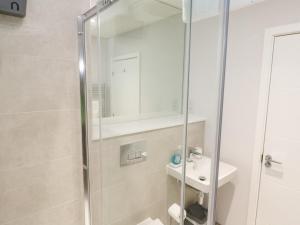 a bathroom with a shower and a sink at Sebastian's View in Falmouth +31 photos