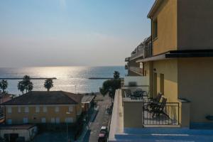 a view of the ocean from a balcony of a building at Hotel Europa in San Bartolomeo al Mare
