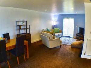 a living room with a couch and a table at Pete's Place - 97a Grantley Gardens - Plymouth Devon in Plymouth