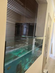 a fish tank in a room with a window at Милый Дом in Vanadzor