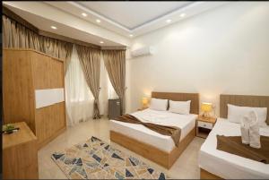 a hotel room with two beds in a room at NEW CITY VIEW in Cairo +42 photos