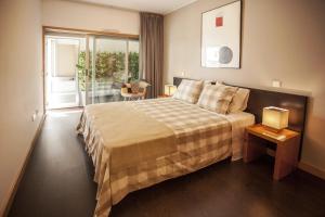 a hotel room with a bed and a balcony at Casa do Sol in Porto