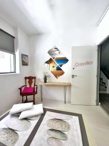 a living room with a refrigerator and a table at Tenerife Experience Hostel in Santa Cruz de Tenerife