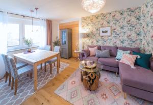 a living room with a purple couch and a table at Berg Apartments in Oberreichenbach