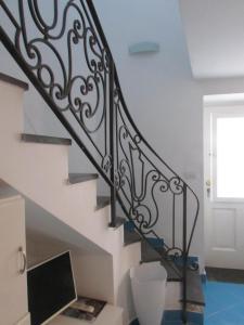 a stairwell with a black and white railing at Piazzetta Sweet Home in Capri