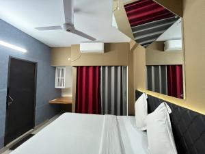 a bedroom with a bed and a red curtain at Hotel Arcane in Cox's Bazar