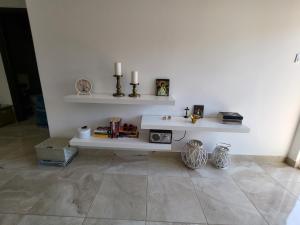 a living room with a white wall with shelves at House Tamaris App.25 in Ðenovići