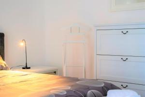 a white bedroom with a bed and a dresser at Casa Spezia - Metro Vicina, Wi-Fi Rapido & Netflix in Turin +25 photos
