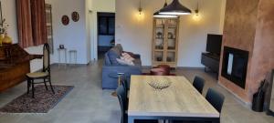 a living room with a table and a couch at Oltre la Siepe Apartment in Nepi