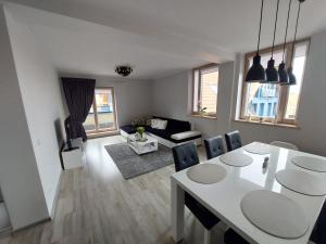 a living room with a white table and chairs at Lighthouse apartment in Nida