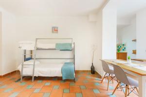 a room with a desk and a bunk bed at Le Grand Bleu - Gioia Apartments in Procida +65 photos