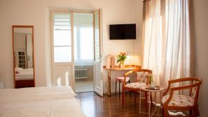Postel nebo postele na pokoji v ubytování Easy Stay by Hotel La Perla