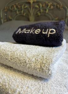 a pile of towels on top of a bed at Pink House in Palaiochóra