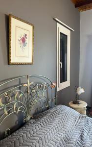 a bedroom with a bed and a picture on the wall at Pink House in Palaiochóra +13 photos