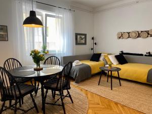 a living room with a dining table and a bedroom at Boennium Apartments Green Oasis in Ljubljana