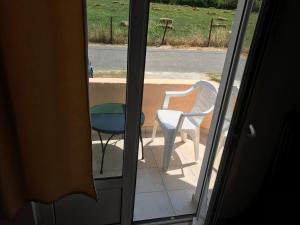 a view of a table and chair from a door at Urban Apartments in Ulcinj