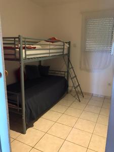 ein Schlafzimmer mit zwei Etagenbetten und einem Fenster in der Unterkunft Ducourneau Grimaldi in Moltifao