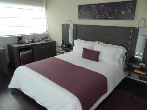 Voodi või voodid majutusasutuse Hotel bh El Poblado toas