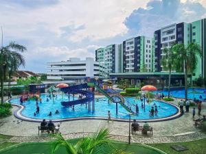 a water park with a slide and people in it at Comfy PoolView@Ipoh Waterpark Netflix(Wifi) in Ipoh
