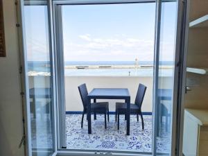 a table and chairs with a view of the ocean at Casetta Mirella in Capri