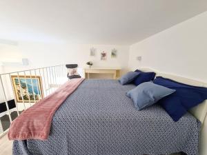 um quarto com uma cama grande e almofadas azuis em Casetta Mirella em Capri