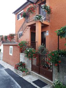 a building with flower boxes and balconies on it at APP Mario Funtana in Funtana +9 photos
