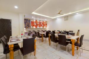 a large dining room with tables and chairs at The Alpino Hotel in New Delhi