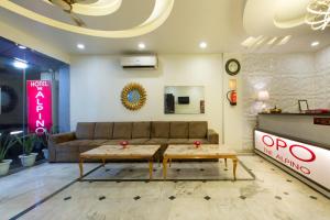 a living room with a couch and two tables at The Alpino Hotel in New Delhi
