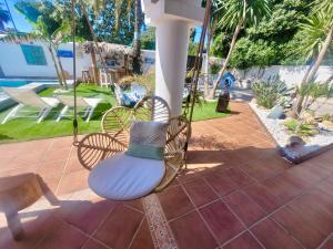 huśtawka z poduszką na patio w obiekcie GATU PREMIUM Villa Lurberri piscina privada, 4 dormitorios, 2 baños, parking , jardines, " Preferente mayores de 25 años y familias " ín y barbacoa w mieście Chiclana de la Frontera