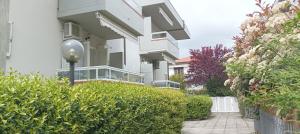 a white building with a street light in front of it at La casina di Ale in Marina di Carrara