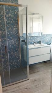 a bathroom with a shower and a sink and a mirror at Appartamenti con 1 e 2 camere Caldiero in Caldiero