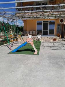 a playground with a giant toothbrush in a yard at Ktima Bavella Apartment Sophia 