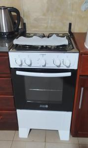 a black and white stove in a kitchen at Miguel Departamentos 1 in Puerto Iguazú