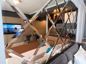 a room with a bed and a dining room at Blue Luxury Studio in Mamaia