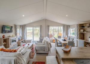 a living room with couches and a table at Docker Holiday Park in Carnforth