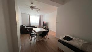a living room with a table and chairs and a couch at 2 room apartment, near OC Galeria, Petržalka in Bratislava