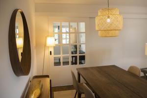 a dining room with a table and a mirror at Mãe - Casas de Selim in Arcos de Valdevez