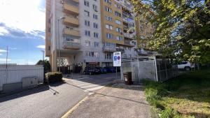 an empty street in front of a tall building at 2 room apartment, near OC Galeria, Petržalka in Bratislava