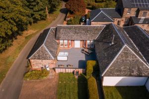 an aerial view of a house with a roof at Auchendennan Farm Self Catering Cottages in Balloch