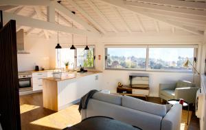 a living room with a couch and a kitchen at Eira - Casas de Selim in Arcos de Valdevez
