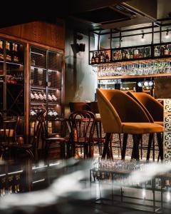 a restaurant with chairs and a bar with wine glasses at The Priory Hotel in Newport