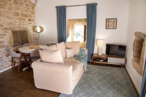 a living room with a couch and a table at Primitiva - Casas de Selim in Arcos de Valdevez