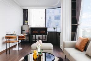 a living room with a couch and a table at Ivy Hotel & Apartment - STAY 24h in Hanoi