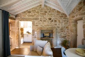 a living room with a stone wall at Primitiva - Casas de Selim in Arcos de Valdevez
