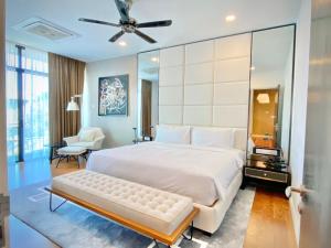 - une chambre avec un grand lit blanc et un ventilateur de plafond dans l'établissement Merissa Luxury Private Pool Villa, à Pantai Cenang